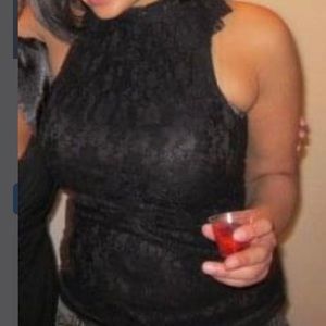 Medium grass black top with ruffles on top. Worn once